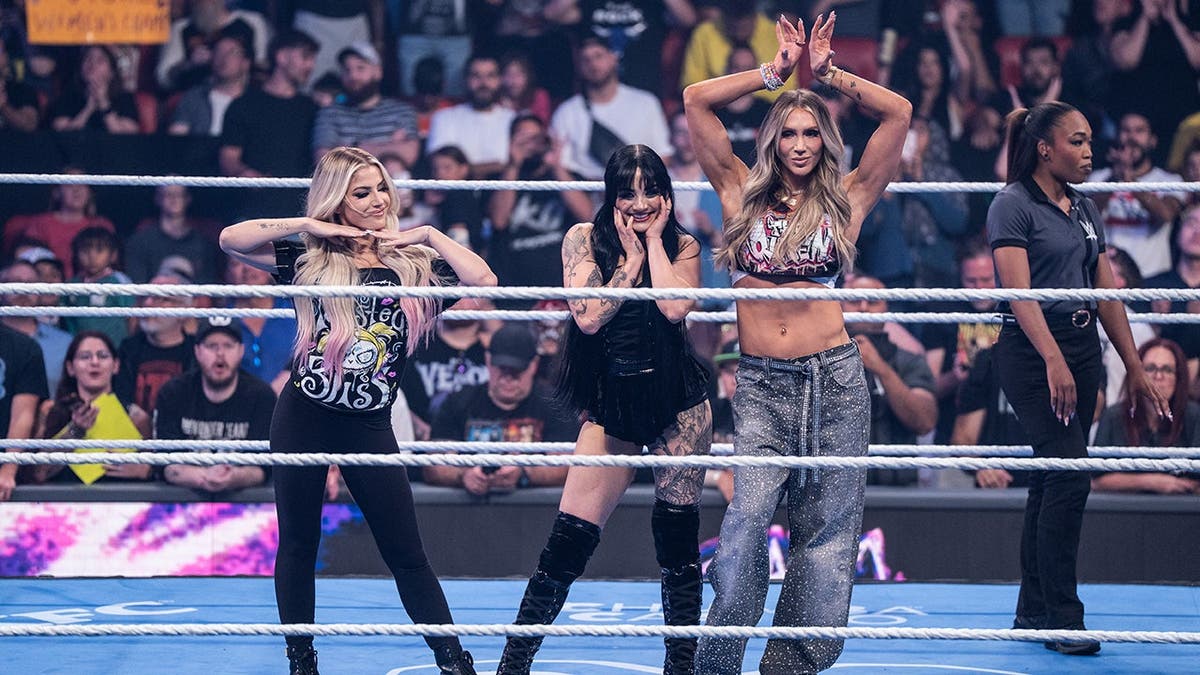 Tatum Paxley, Alexa Bliss, and Charlotte Flair make their entrance during SmackDown.