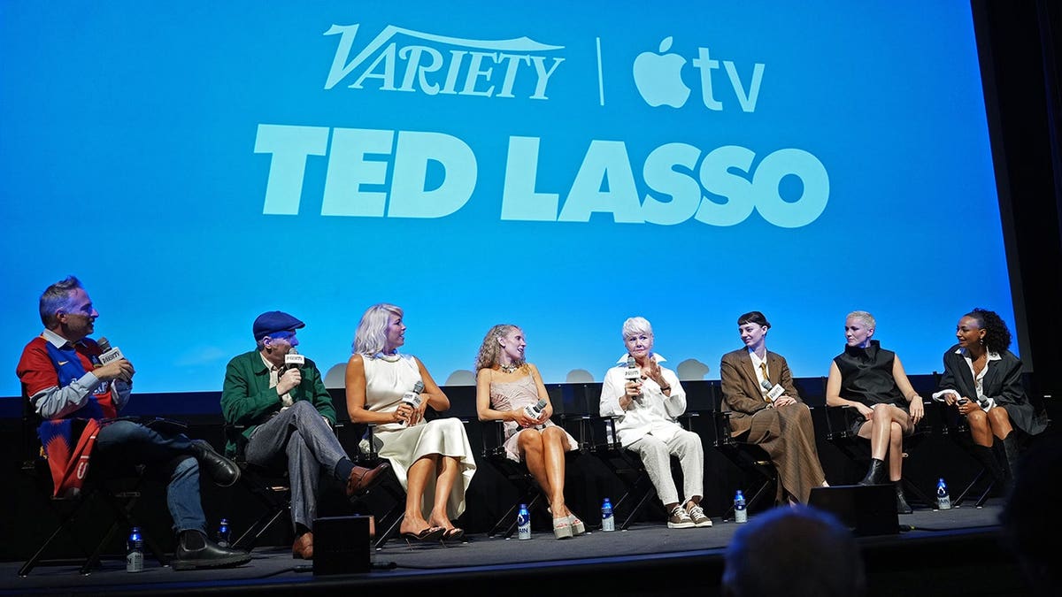Michael Schneider, Brendan Hunt, Hannah Waddingham, Juno Temple, Annette Badland, Tanya Reynolds, Jude Mack and Abbie Hern pose at a Ted Lasso screening.