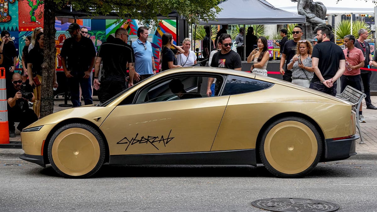 A Tesla Cybercab picks up passengers in Austin, Texas.