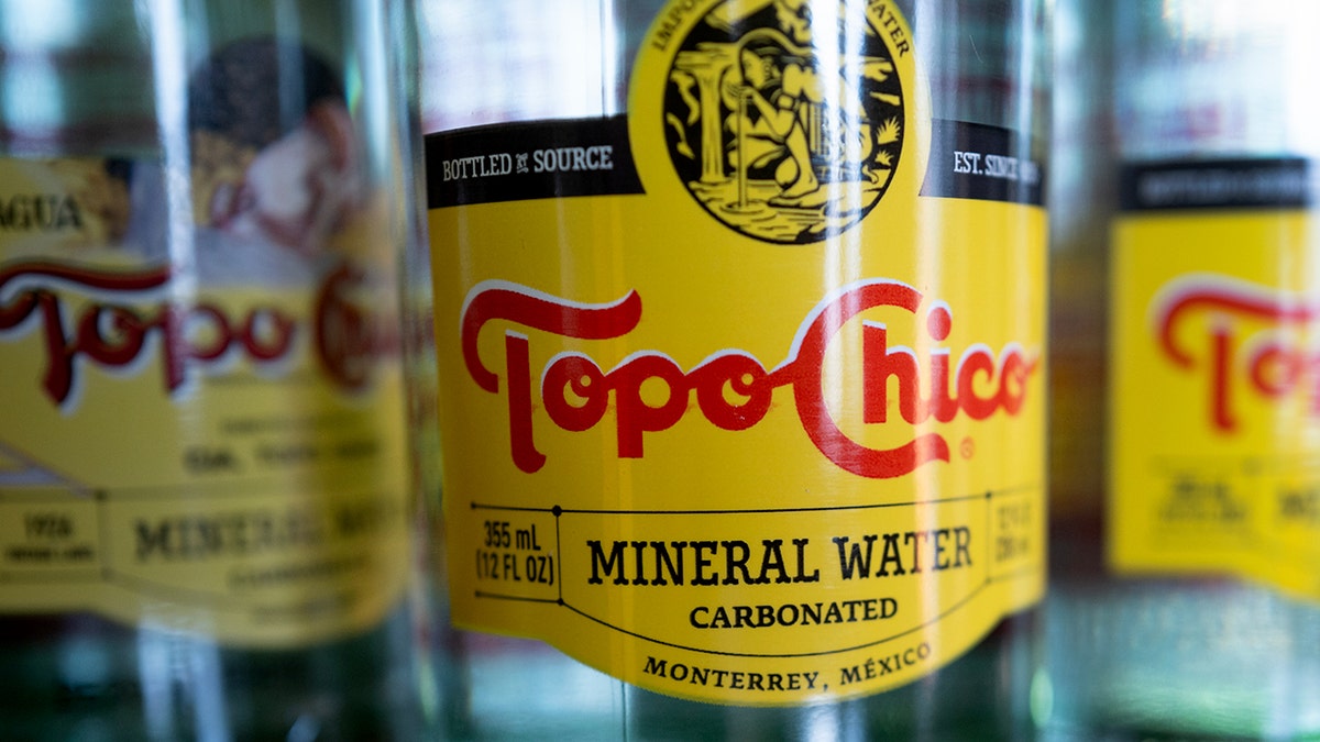 A close-up look at the Topo Chico mineral water label.
