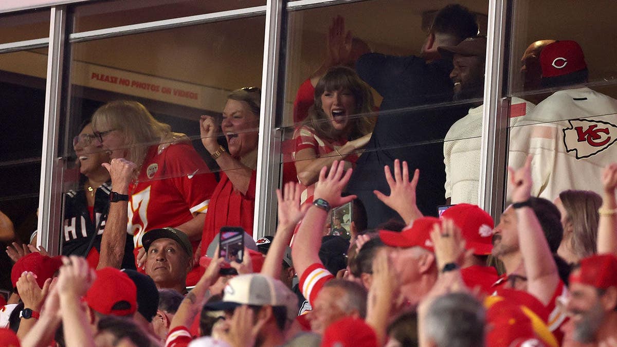 Donna Kelce, Taylor Swift and Jason Kelce celebrate after a reception at Arrowhead Stadium.