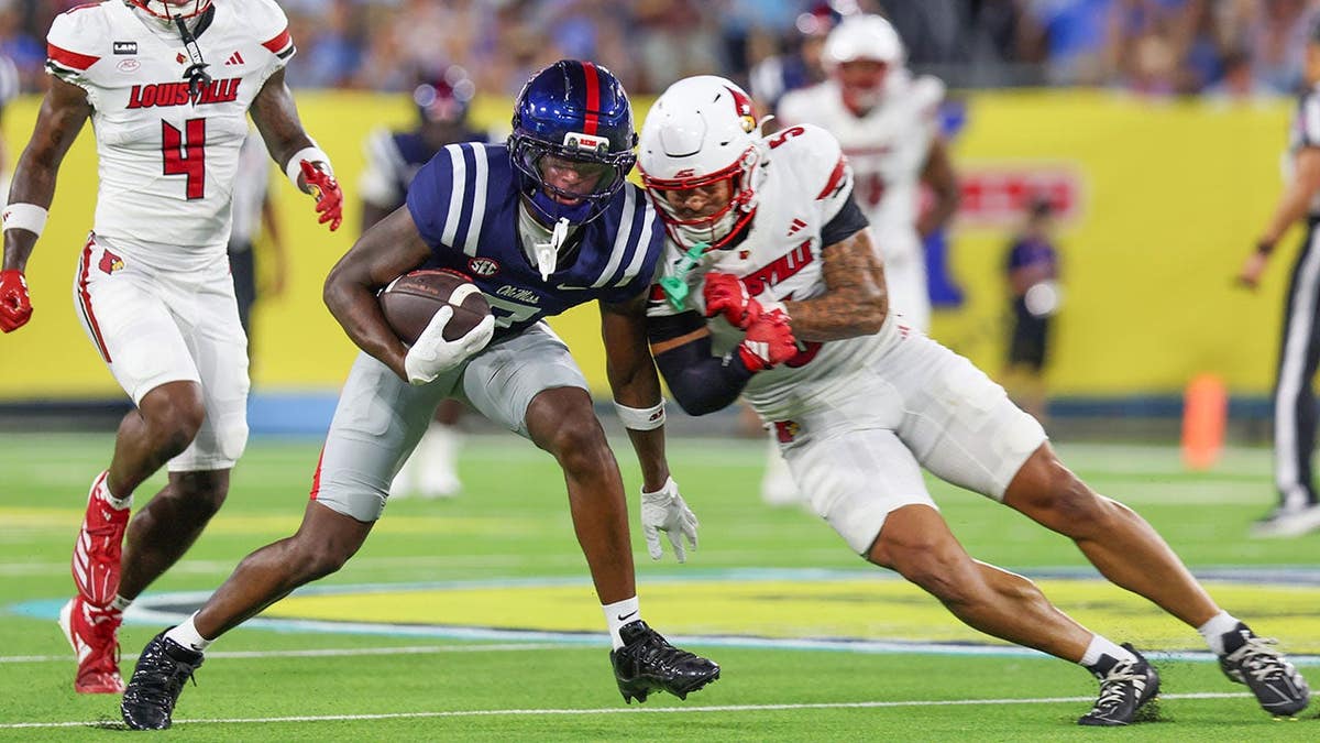 Traylon Ray #7 of Ole Miss is hit after a catch during a game against Louisville.