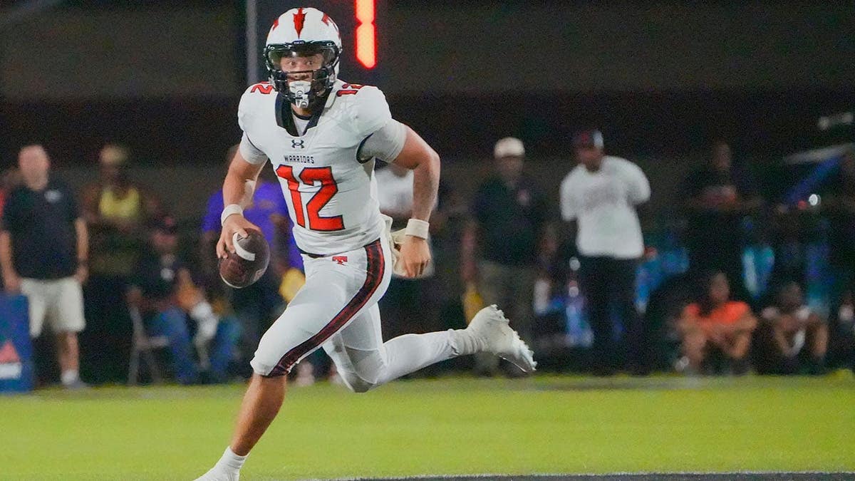 Trent Seaborn rolls out during a football game.