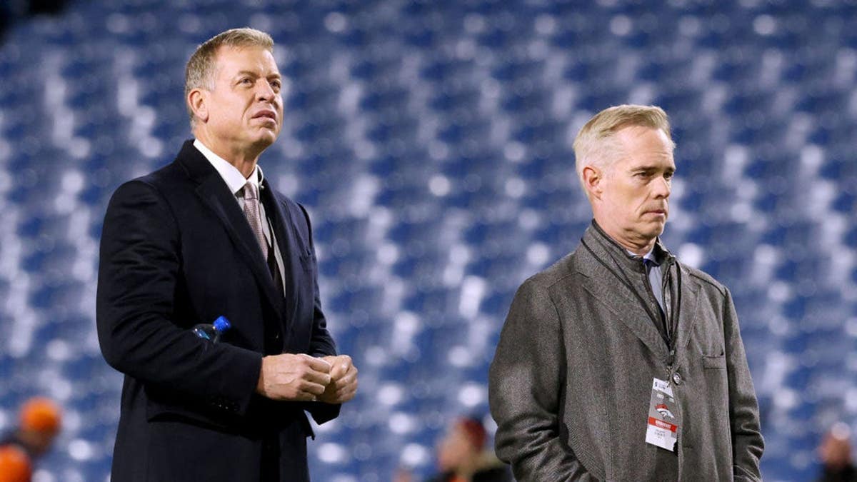 Troy Aikman and Joe Buck look on before a game at Highmark Stadium.