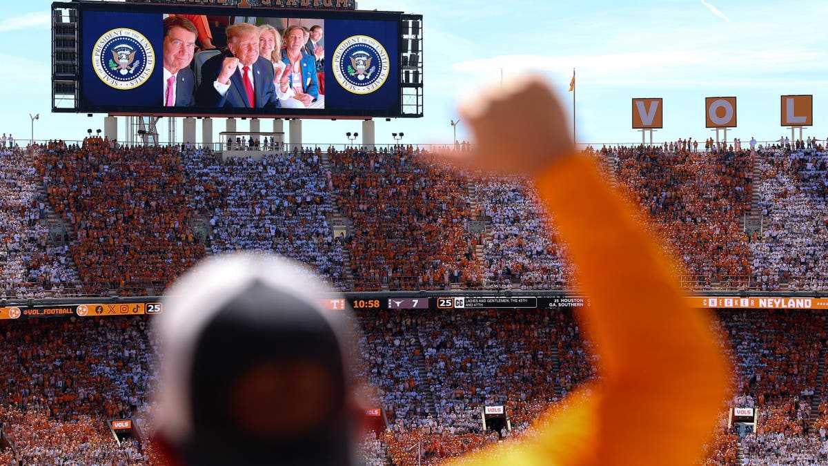 President Donald Trump, Sen. Bill Hagerty and Sen. Marsha Blackburn appear on a video screen at Neyland Stadium.