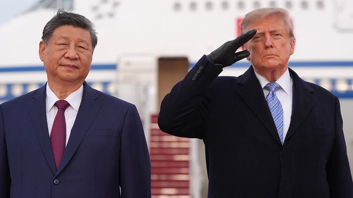 President Donald Trump and Xi Jinping stand together at an arrival ceremony.