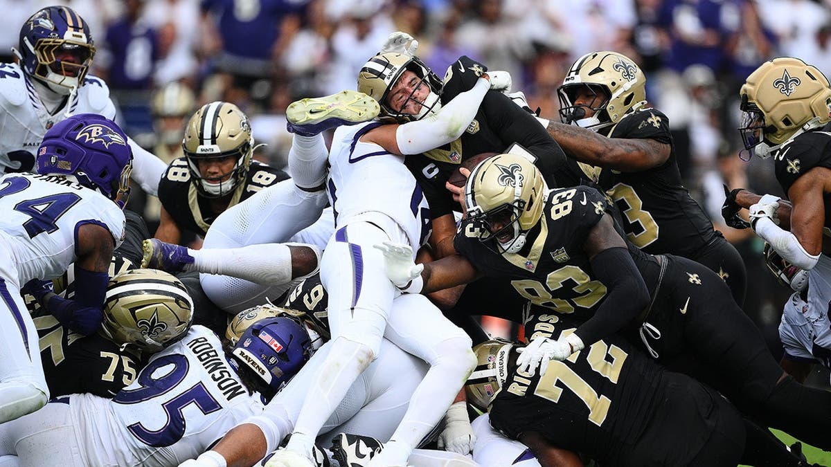 Tyler Shough runs with the ball during an NFL game in Baltimore.