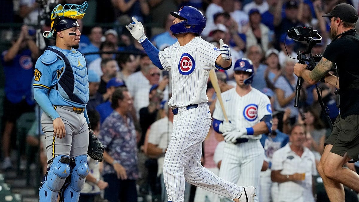 Tyrone Taylor celebrates after hitting a two-run home run during a baseball game.