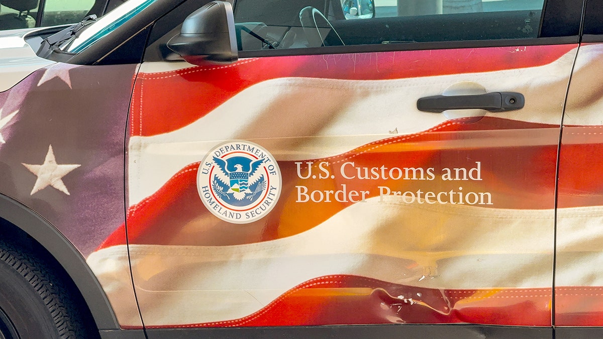 A U.S. Customs and Border Protection wrap of the American flag is shown on a vehicle.