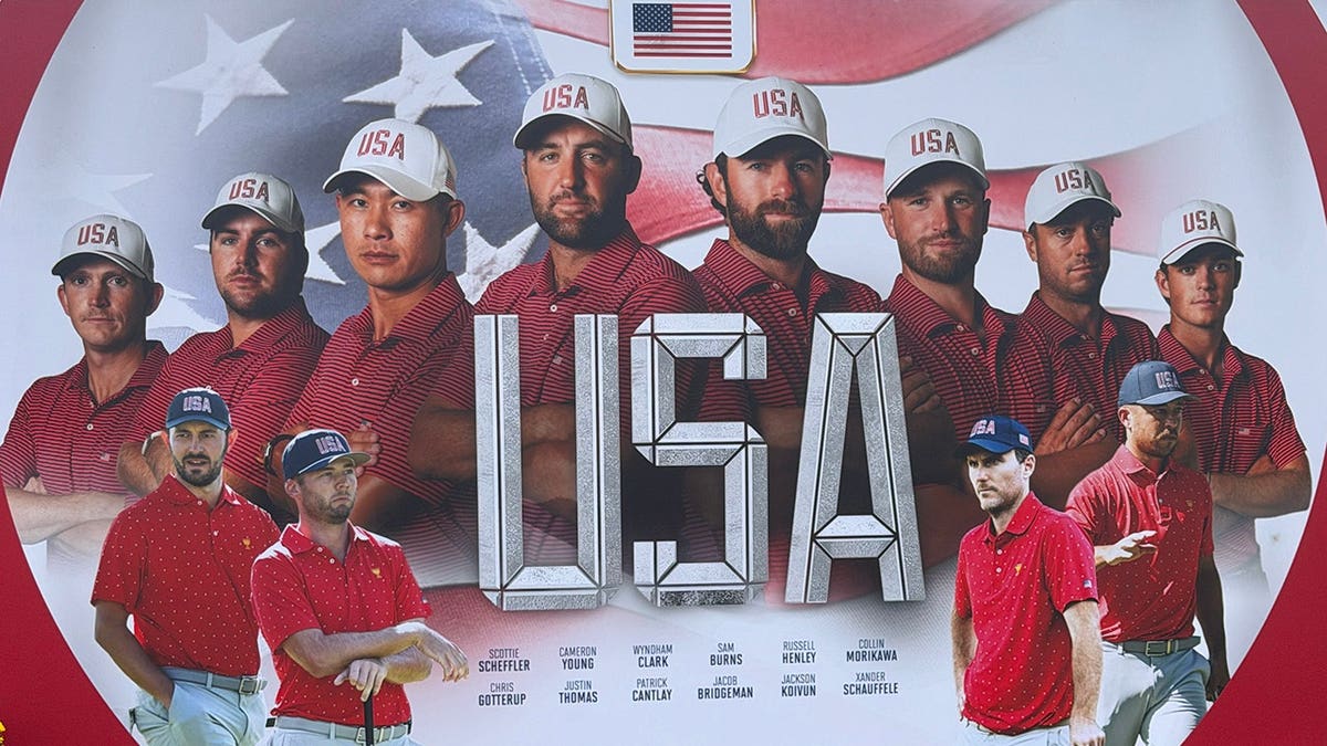 USA golf team players wearing red shirts and USA caps in front of an American flag and large USA lettering.
