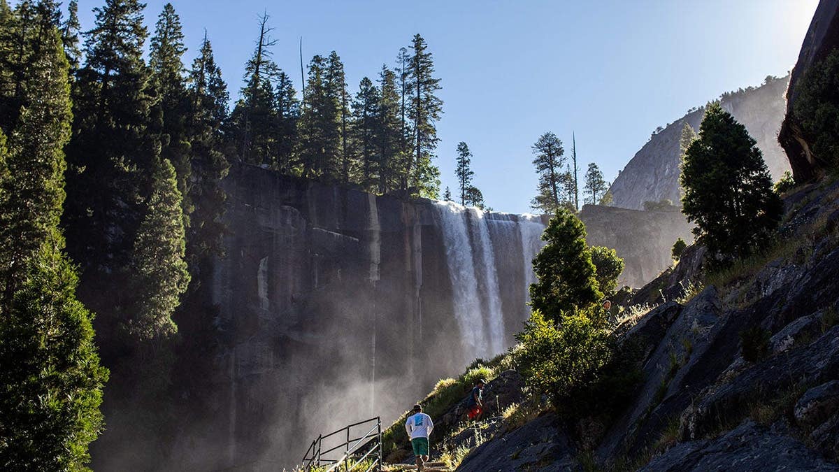 Visitors hike the Mist Trail toward Vernal Fall in Yosemite National Park, California.
