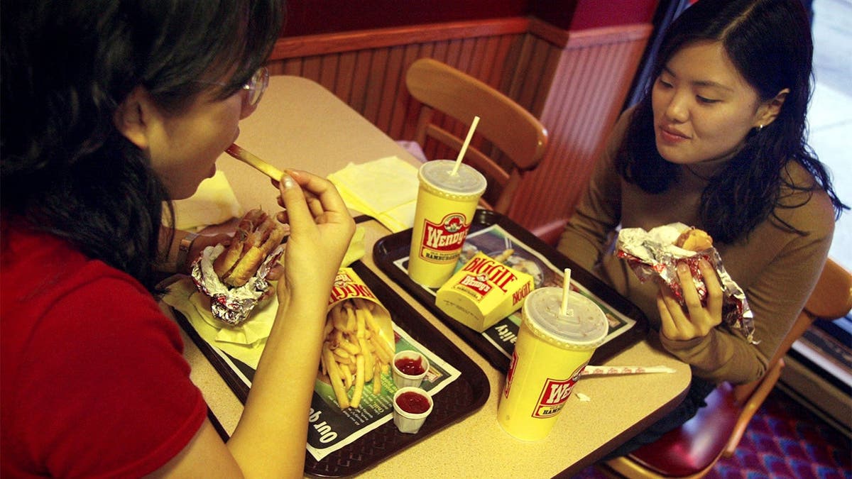 Two friends eat Wendy's food in 2002.