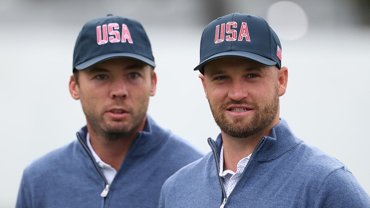 Wyndham Clark and Sam Burns stand during a practice round at Medinah Country Club.