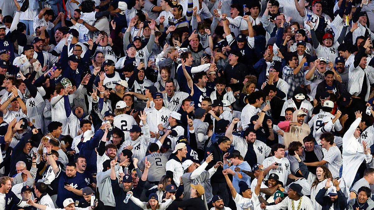 New York Yankees fans celebrate after a grand slam by designated hitter Ben Rice in the eighth inning. The Boston Red Sox played the New York Yankees in Game 1 of the 2026 Wild Card Series at Yankee Stadium on September 29, 2026. (Photo by Danielle Parhizkaran/The Boston Globe via Getty Images)