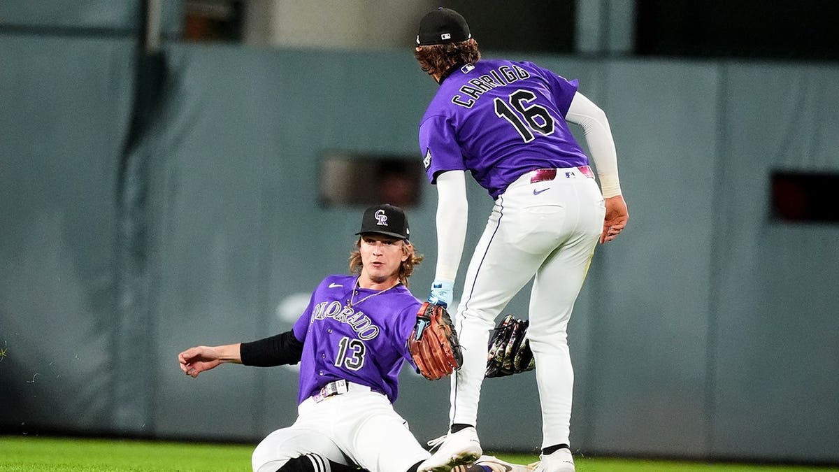 Zac Veen catches a fly ball as Cole Carrigg looks on during a baseball game in Denver.