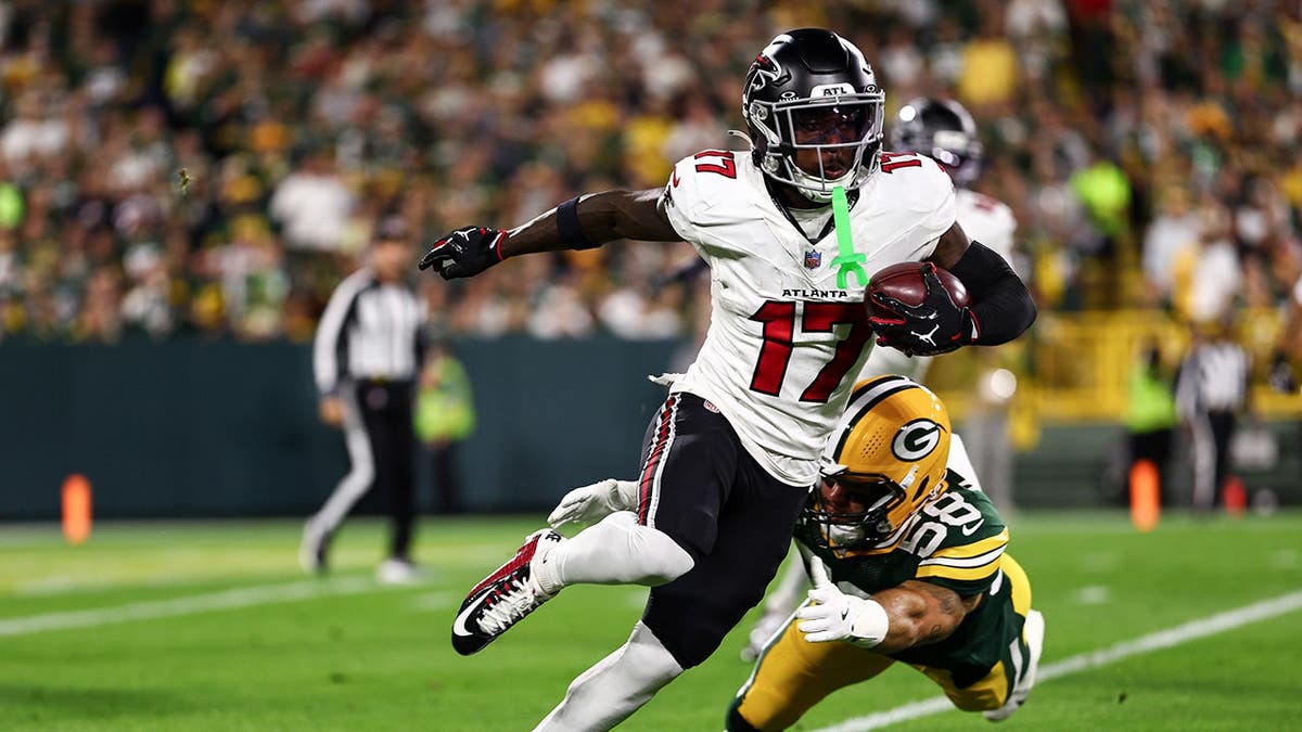 Zachariah Branch runs with the ball during a game at Lambeau Field.