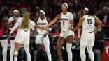 Angel Reese celebrating with teammates during a WNBA playoff game