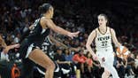 A'ja Wilson playing defense against Caitlin Clark during a WNBA playoff game