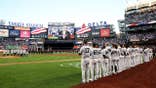 Yankees players standing on the field a 9/11 commemoration