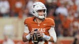 Arch Manning drops back to pass during a college football game