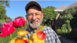 Zafar Nomani holds a bouquet of flowers.