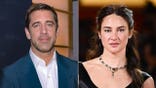 Aaron Rodgers and Shailene Woodley stand side by side.
