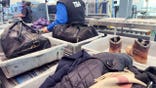 Travelers move through a TSA security checkpoint at an airport.