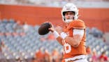 Arch Manning warms up before a game at Darrell K Royal-Texas Memorial Stadium.