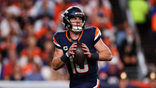 Bo Nix #10 looks to pass during a game at Empower Field at Mile High.