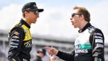 Brad Keselowski and Carson Hocevar talk on the grid during NASCAR practice.