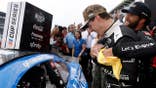 Bubba Wallace hugs Corey Heim in victory lane after the Brickyard 400.