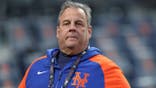 Chris Christie stands on the field at Citi Field during the National League Championship Series.