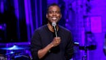 Chris Rock performs onstage with a microphone at Beacon Theatre.