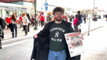A protestor wears a shirt that says, "COMMUNISM WILL WIN."