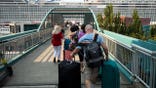 Cruise ship passengers walk toward Pier 66 in Seattle.