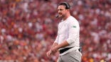 Dan Lanning stands on the field during a college football game in Los Angeles.