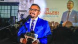 David Morales speaks at a podium during his acceptance speech at Riff Raff Bookstore.
