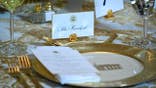 Donald Trump sits at a table during a dinner with donors in the White House East Room.