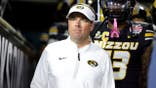 Eli Drinkwitz of Missouri Tigers stands in stadium tunnel before game.
