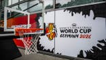 Basketball goal stands in front of a FIBA Women's Basketball World Cup 2026 logo outside Max Schmelling Hall.