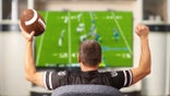A man watching football on TV