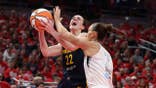 Caitlin Clark shoots the ball while defended by Stephanie Talbot during a WNBA playoff game.