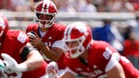 Josh Hoover, Indiana Hoosiers quarterback, drops back to pass during a college football game.