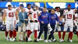 Jaxson Dart walks off the field with an injury during an NFL game.