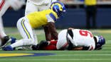Jaxson Dart lies on the ground after being tackled by Byron Young during the first quarter.