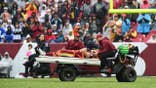 Washington linebacker Leo Chenal is carted off the field at Northwest Stadium.