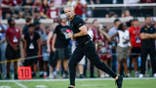 Mike Norvell stands on the field before a game at Doak S. Campbell Stadium.