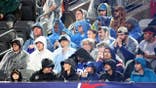 New York Giants fans sit in the rain at MetLife Stadium.