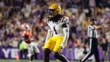 Princewill Umanmielen celebrates after a stop during LSU football game at Tiger Stadium.