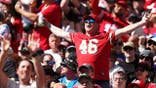 Fans cheer in the stands during an NFL game at Melbourne Cricket Ground.